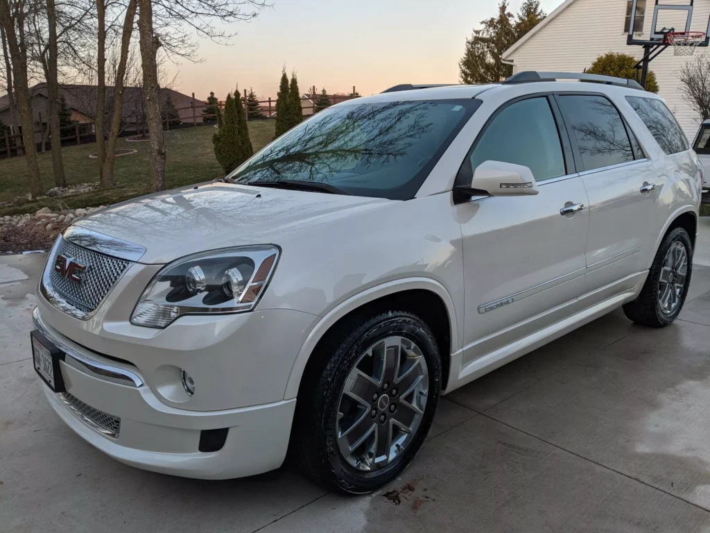 Side view of the white SUV, highlighting its smooth, polished exterior after professional detailing.