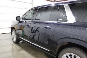 Passenger side exterior of a Cadillac showing a smooth, shiny surface after professional detailing.