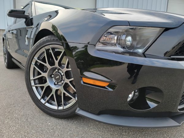 Ceramic Coating Installation: Ceramic coated Shelby Cobra close-up showing deep mirror-like paint reflection after premium detailing.